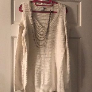 Off white sweater, open shoulders.